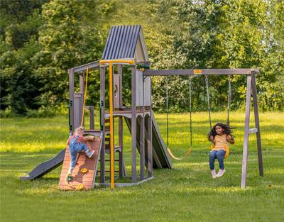 Two Kids Playing on Jack and June Haven Swing Set